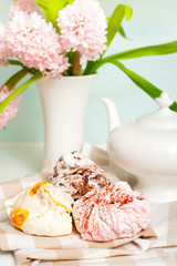 Fototapeta na wymiar Spring tea set with multicolored fruit fluffy meringue