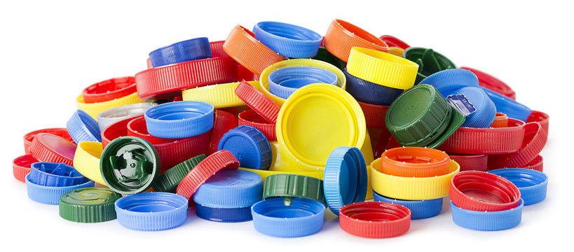 Heap of plastic bottle caps isolated on white background.