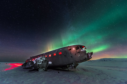 northern lights over plane wreck  in Vik, Iceland