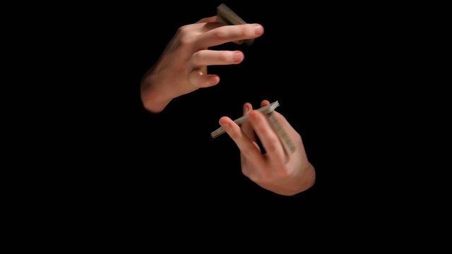 Magic trick with playing cards on black background, slow motion