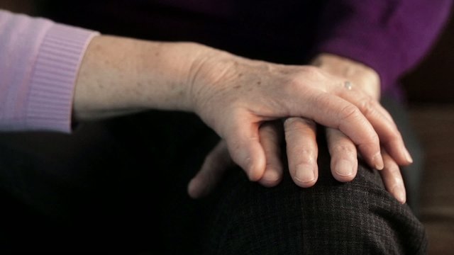 Hands of elderly couple
