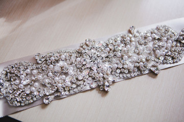 Obraz na płótnie Canvas Bridal belt with shiny rhinestones. Wedding luxury accessories