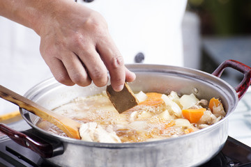 Chef putting Japanese curry paste for cooking
