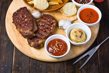 Beef Steaks with Sauces, French Fries and Vegetables