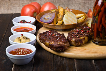Beef Steaks with Sauces, French Fries and Vegetables