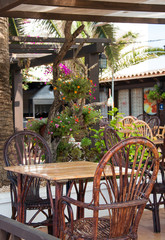 Mediterranean cafe terrace exterior with chairs.