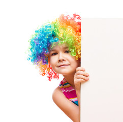 Girl in clown is holding blank banner