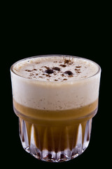 Cold coffee with ice in glass isolated on black