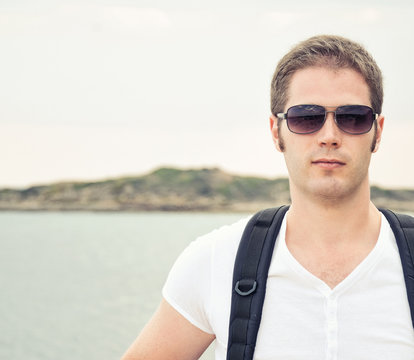 Portrait of male tourist with backpack. Place for text.