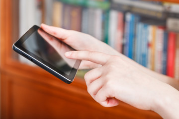 finger pressing tablet pc in library