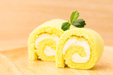 Roll cake on wooden background