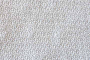 Macro of a white embossed paper napkin texture