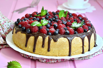 Berry cake with sour cream and chocolate glaze.