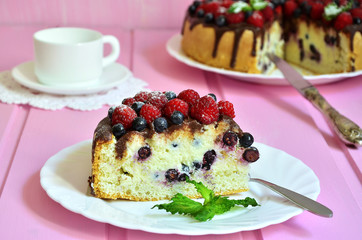 Berry cake with sour cream and chocolate glaze.