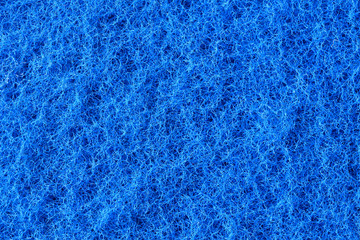 Fototapeta na wymiar Macro of blue synthetic sponge texture, scrub side