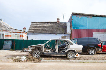 old disassembled car near country car workshop