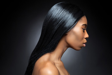 Profile of an young black beauty with long straight hair