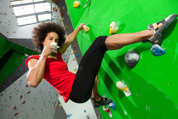 Fototapeta premium woman on artificial climbing wall