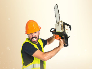 Workman with chainsaw over white background
