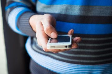 Close up of a man using mobile smart phone
