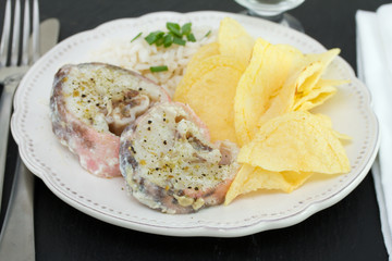 boiled fish with rice and chips on plate