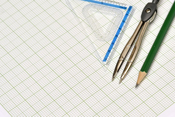 Mathematical instruments and pencil on graph paper. - 78383498