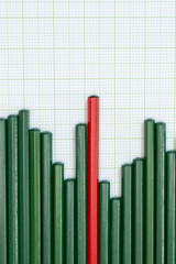 Back of pencils arrangement in pattern of graph on graph sheet.