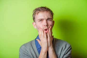 Businessman with big headache touching head
