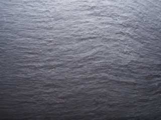 Rough graphite background. Closeup shot.