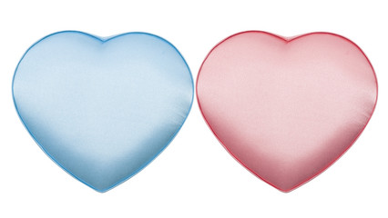 Couple of silk boxes in form of heart, pink and blue, isolated