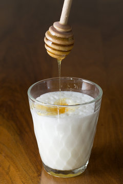 Glass of Hot Foamed Milk with Honey