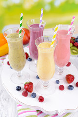 Delicious berry cocktails on table on bright background