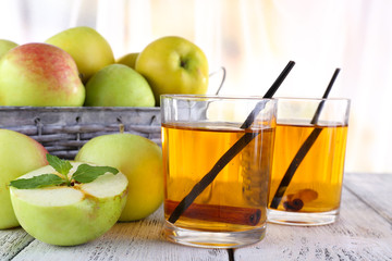 still life with apple cider and fresh apples on wooden table