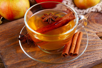 Composition of  apple cider with cinnamon sticks, fresh apples,