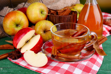 Composition of  apple cider with cinnamon sticks, fresh apples