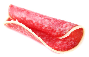 Slice of salami isolated on white background