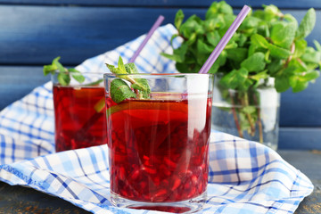 Pomegranate drink in glasses with mint and slices of lime