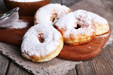 Delicious donuts with icing and powdered sugar