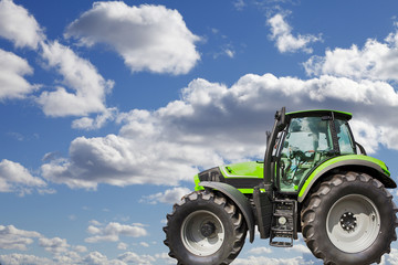 tractor, blue sky with white puffy clouds