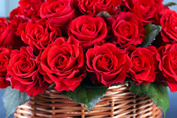 Bouquet of red roses in basket close up