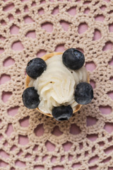 Sweet tartlets filled with cream and blueberry, raspberry and ma