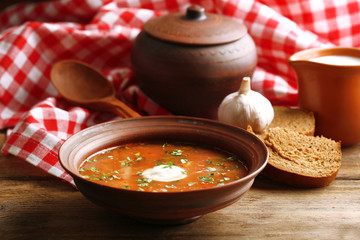 Ukrainian beetroot soup - borscht in bowl and pot,