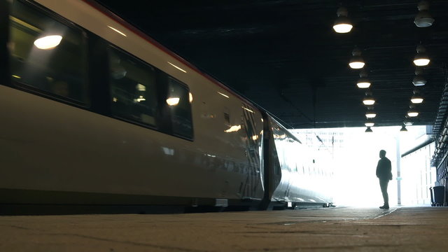 Train arriving at a station platform.