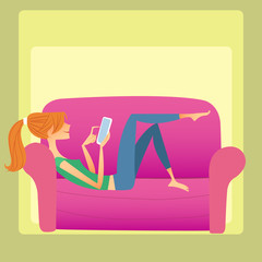 The girl lies on the sofa and reads a smartphone