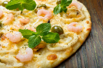 Delicious seafood pizza with olives