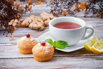 Cup of tea with muffins and ginger