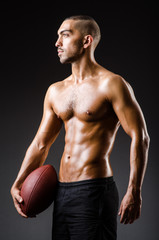 Fototapeta premium Muscular football player with ball