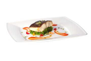 a piece of fried fish on white plate