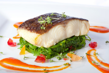 a piece of fried fish on white plate