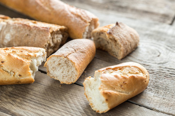 Three baguettes on the wooden background